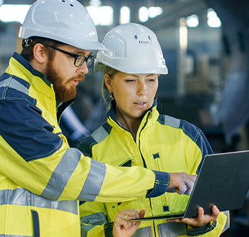 Two workers in brightly colored coats