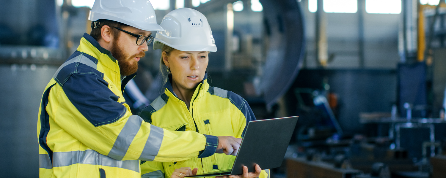 Two workers in brightly colored coats